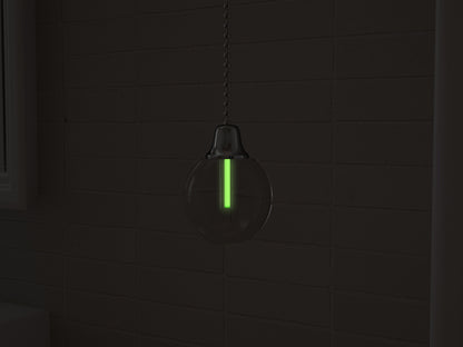 Vega tritium light pull with green glowing vial in the dark