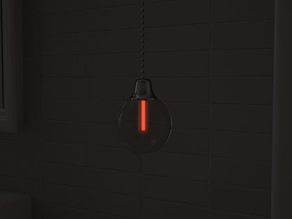 Vega tritium light pull with red glowing vial in the dark